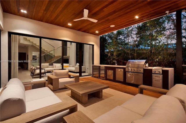 view of patio featuring an outdoor living space, a grill, an outdoor kitchen, and ceiling fan