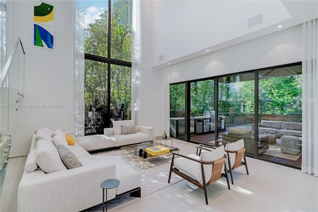 living room featuring a wealth of natural light and a high ceiling