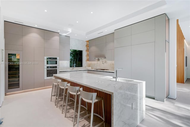 kitchen featuring sink, gray cabinetry, and a large island