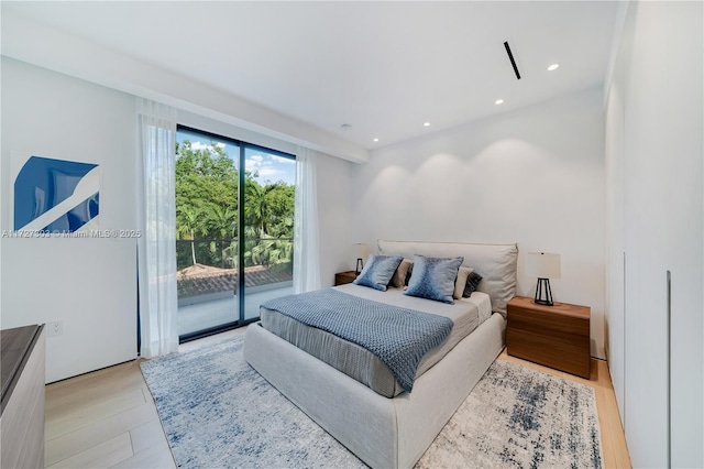 bedroom with access to exterior and light hardwood / wood-style floors