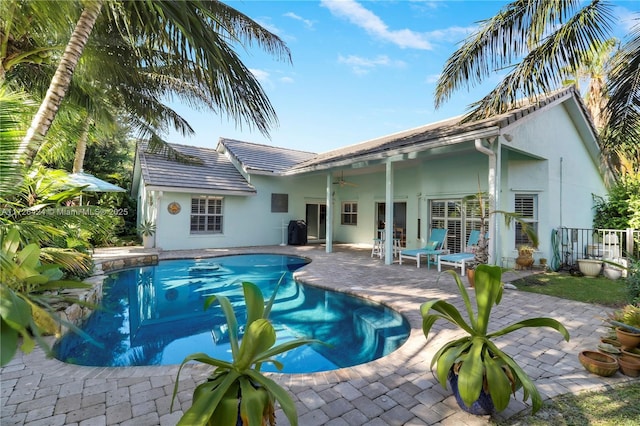 view of pool with ceiling fan and a patio