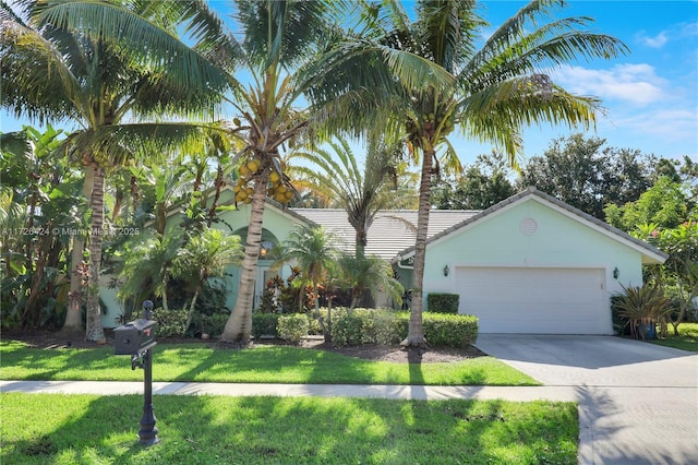 view of front facade featuring a front lawn and a garage