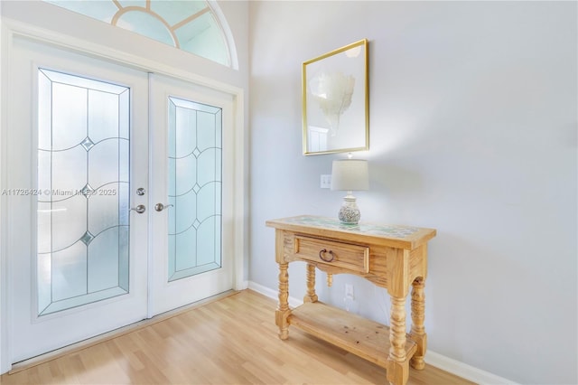 foyer entrance featuring french doors and wood-type flooring