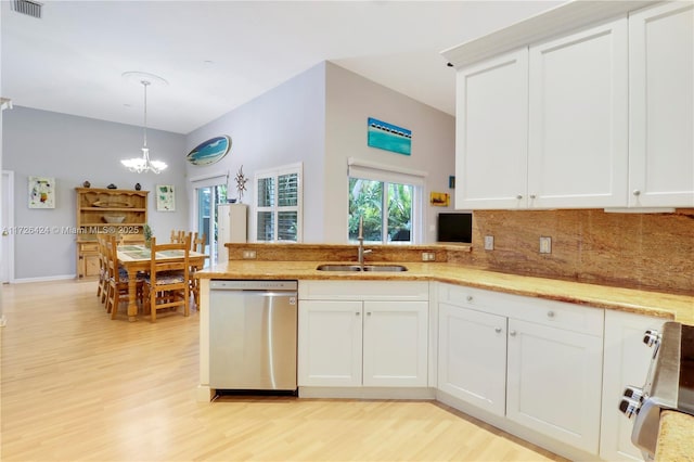 kitchen featuring hanging light fixtures, range, stainless steel dishwasher, white cabinets, and sink