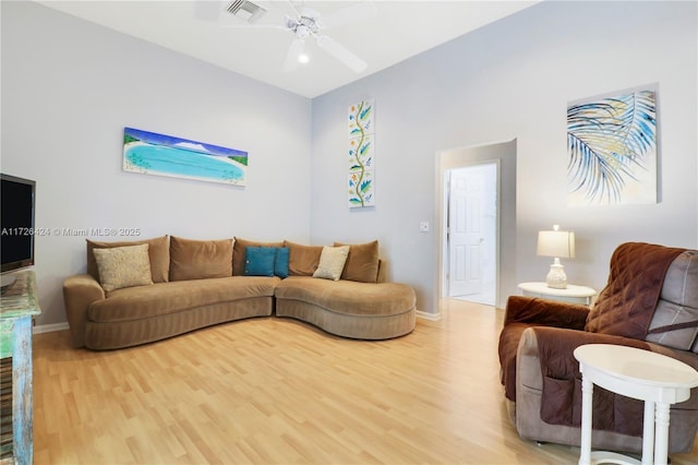 living room with ceiling fan and hardwood / wood-style floors