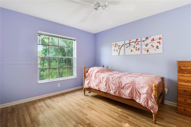 bedroom with ceiling fan and light wood-type flooring