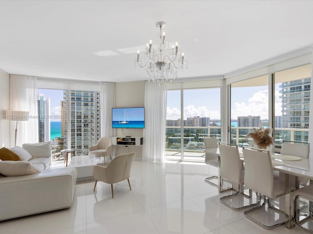 tiled living room featuring an inviting chandelier, floor to ceiling windows, and a wealth of natural light