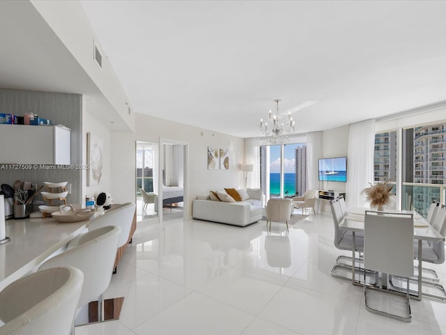 living room with light tile patterned floors and an inviting chandelier