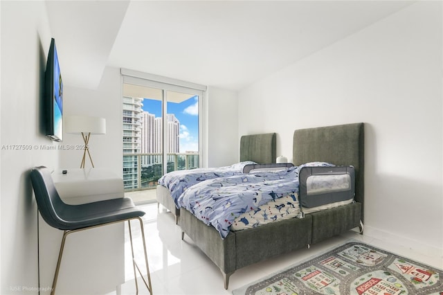 tiled bedroom featuring access to outside and expansive windows