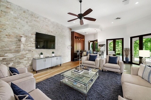 living room with ceiling fan and light wood-type flooring