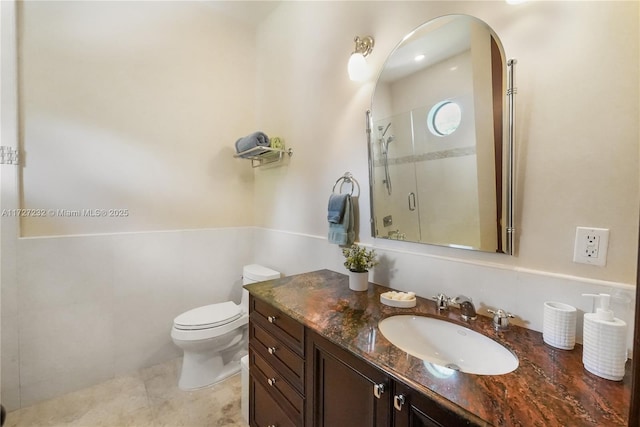 bathroom featuring vanity, an enclosed shower, and toilet