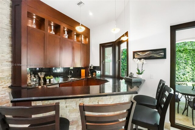 dining space featuring a chandelier, sink, and ornamental molding