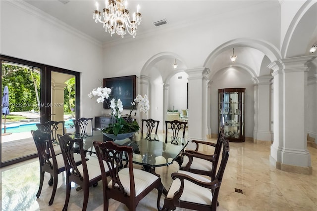 dining room with a notable chandelier, decorative columns, visible vents, ornamental molding, and arched walkways