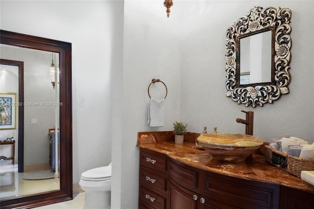 bathroom with toilet and vanity