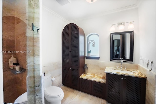 bathroom with walk in shower, toilet, tile walls, ornamental molding, and vanity