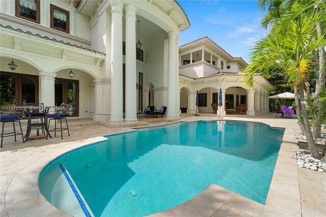 view of pool featuring ceiling fan and a patio area