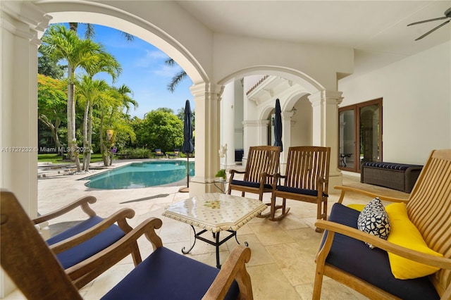 outdoor pool featuring a ceiling fan and a patio