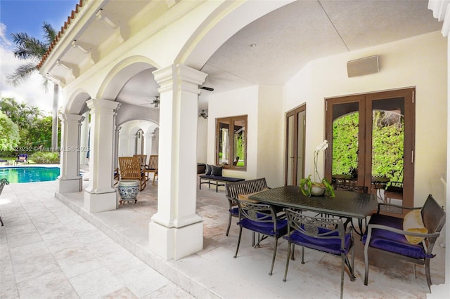 view of patio / terrace featuring an outdoor pool, french doors, and outdoor dining area