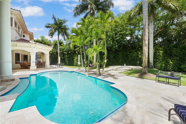 view of pool with french doors and a patio area