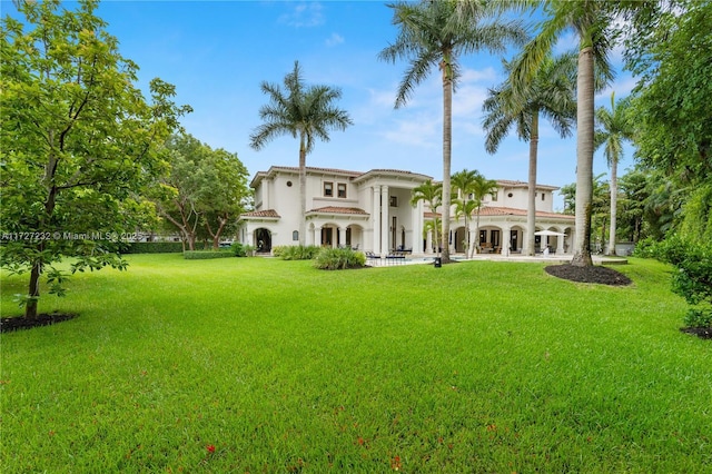 rear view of house with a yard