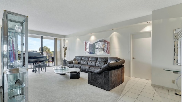 living area featuring a textured ceiling, light tile patterned floors, and light colored carpet