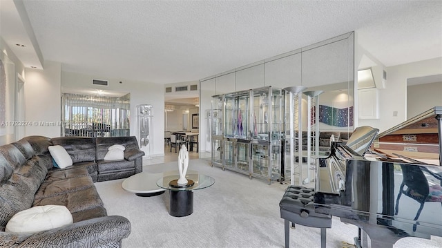 carpeted living area with visible vents and a textured ceiling