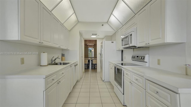 kitchen featuring white cabinetry, white appliances, light tile patterned flooring, and sink