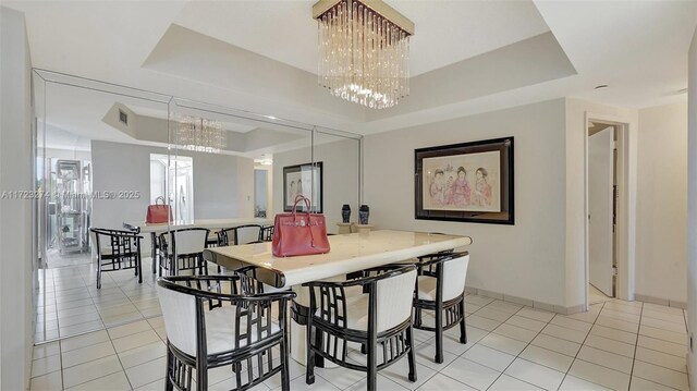 20281 E Country Club Dr Unit M6, Aventura, FL 33180 - dining area with a tray ceiling, a chandelier, light tile patterned floors, and baseboards
