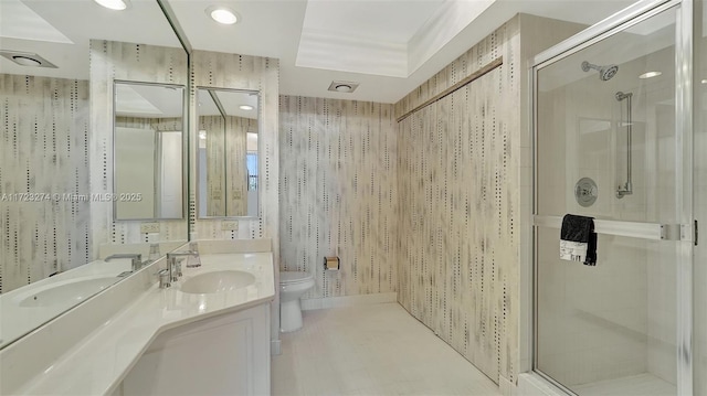 full bath with a stall shower, vanity, toilet, and wallpapered walls