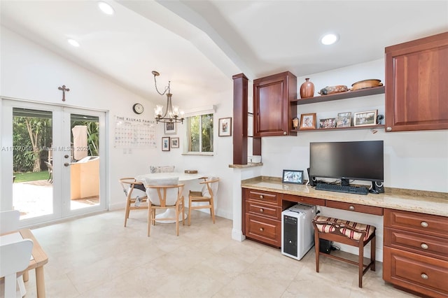 office area with an inviting chandelier, built in desk, vaulted ceiling, and a wealth of natural light