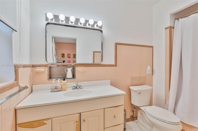 bathroom with tile walls, vanity, and toilet