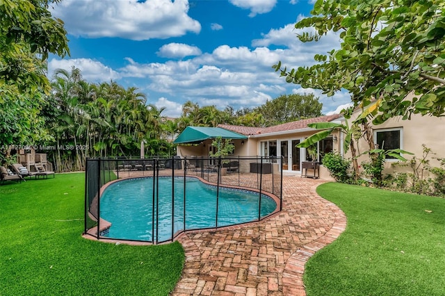 view of pool featuring a yard and a patio