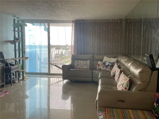 tiled living room featuring expansive windows and a textured ceiling