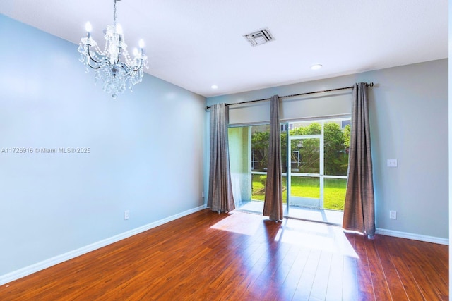 unfurnished room with a notable chandelier, recessed lighting, visible vents, baseboards, and wood-type flooring