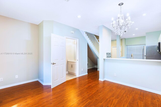 unfurnished living room featuring baseboards, wood finished floors, and recessed lighting