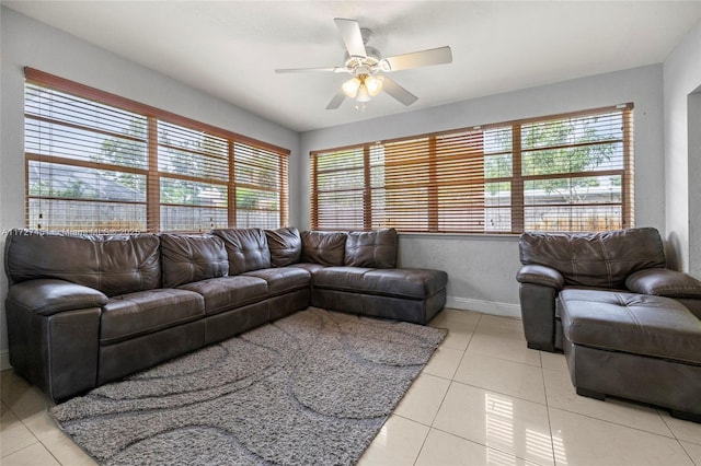 living room featuring ceiling fan, light tile patterned floors, and a healthy amount of sunlight