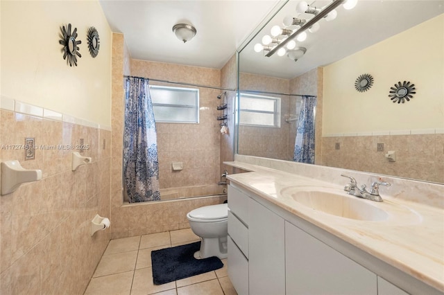 full bathroom featuring shower / bath combo with shower curtain, tile walls, tile patterned floors, and vanity