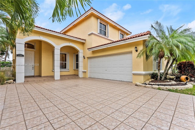 mediterranean / spanish home with a garage