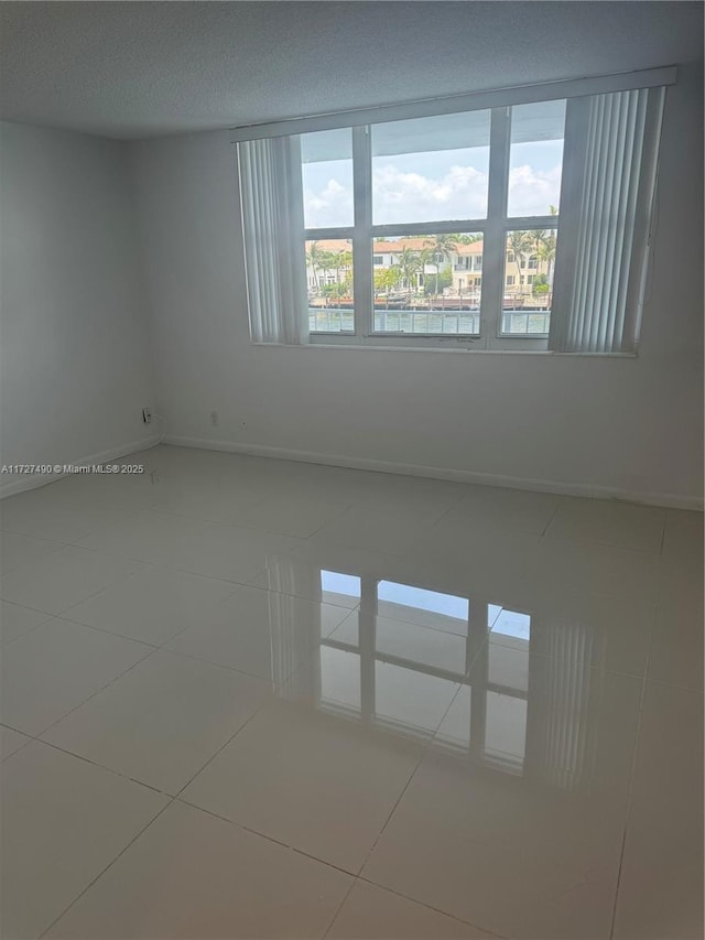 unfurnished room featuring tile patterned floors