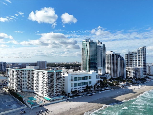 property's view of city featuring a view of the beach and a water view