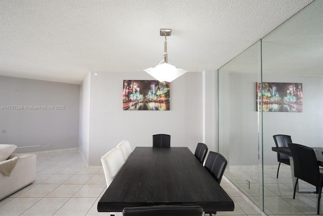 tiled dining room featuring a textured ceiling