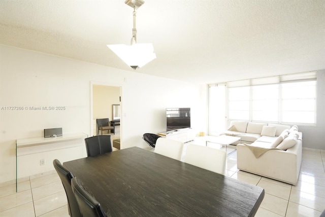 dining room with a textured ceiling and light tile patterned floors