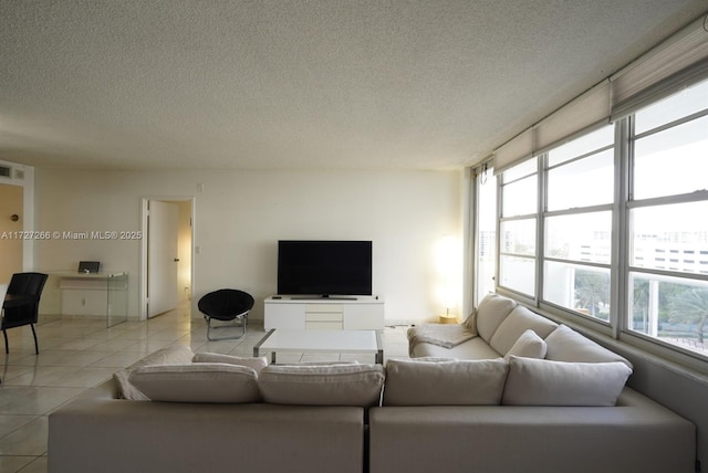 tiled living room with a textured ceiling and a wealth of natural light