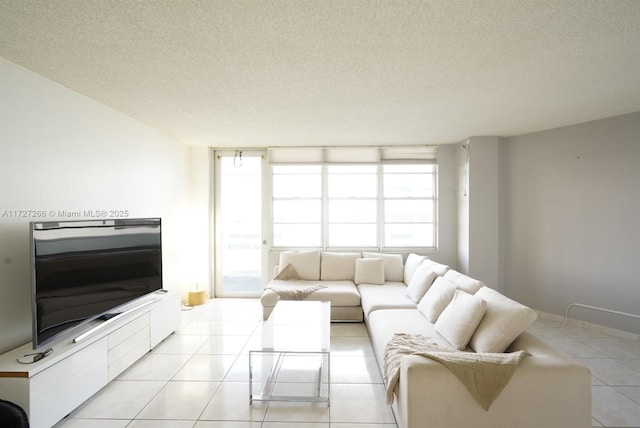 tiled living room featuring a textured ceiling