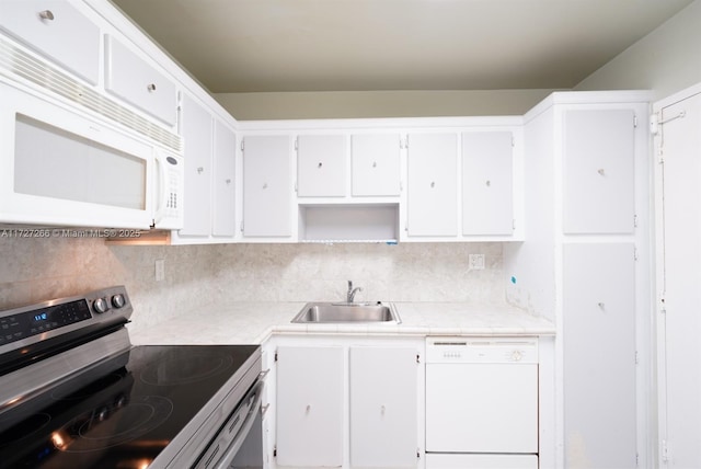 kitchen with backsplash, sink, white appliances, and white cabinetry