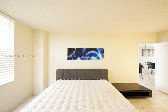 tiled bedroom featuring a textured ceiling