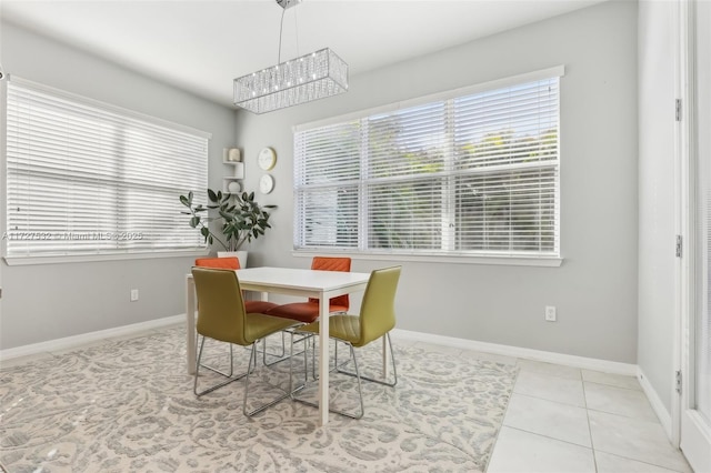 dining space with light tile patterned floors and a chandelier