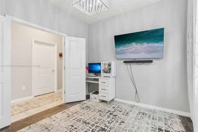 home office featuring a chandelier