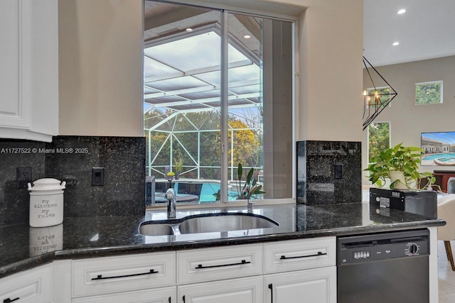 kitchen with a healthy amount of sunlight, dark stone counters, black dishwasher, and white cabinetry