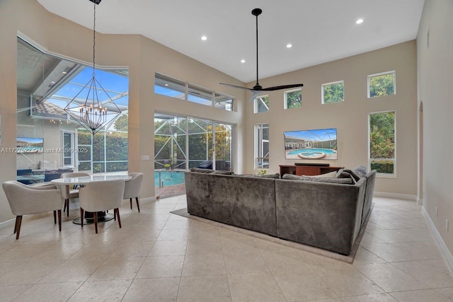 living room featuring light tile patterned flooring and ceiling fan with notable chandelier